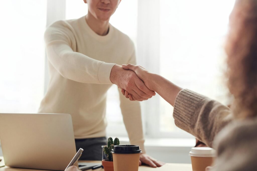 two office workers shaking hands